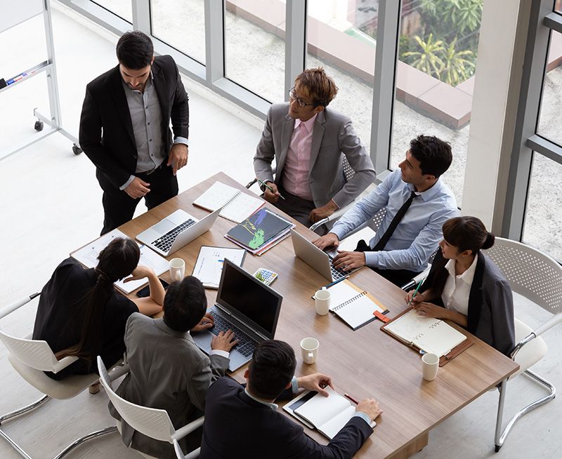 Group of Business People in Discussion at Table